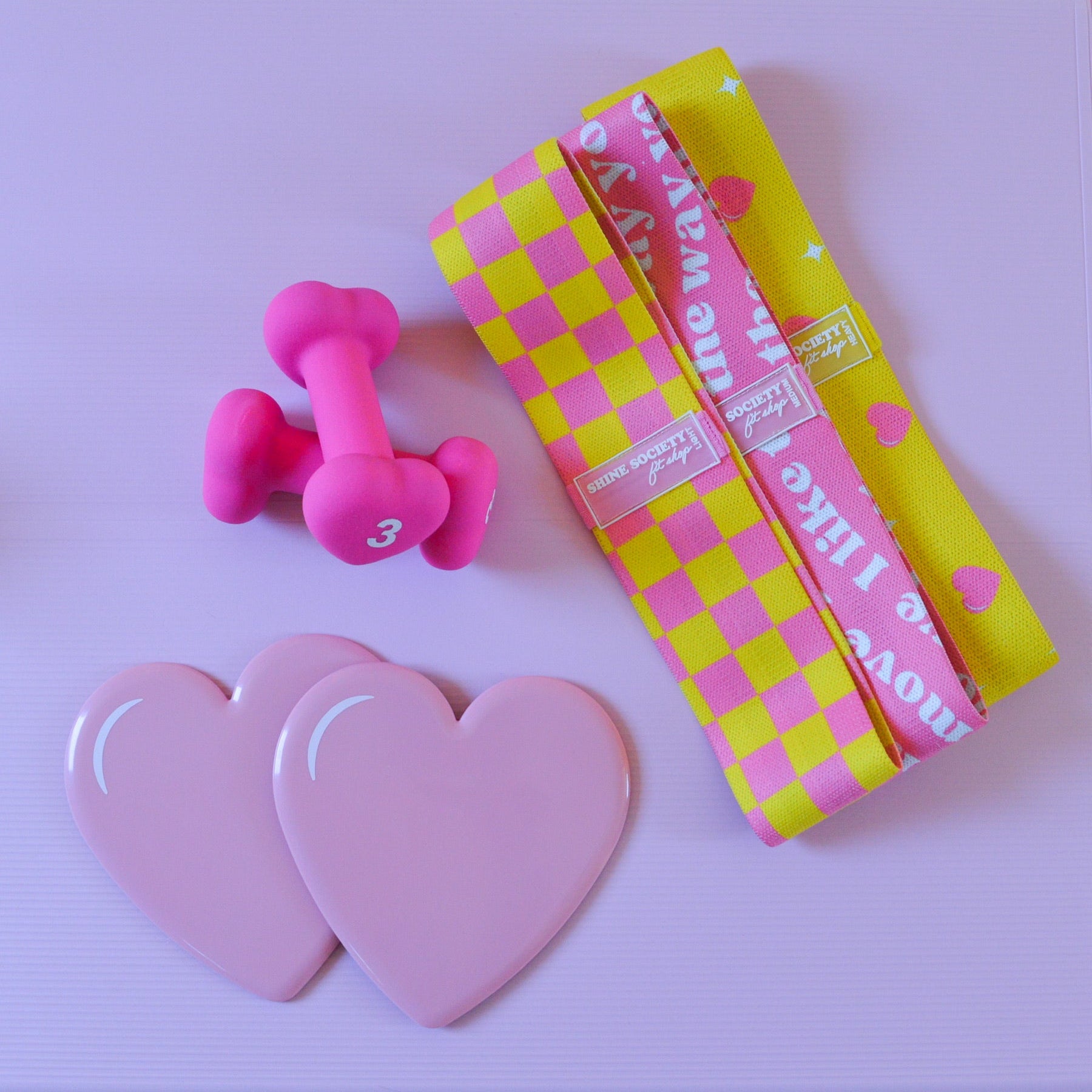 3 hip Resistance bands, a set of heart shaped sliding disks, a set of 3 pound dumbbells