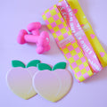 3 hip resistance bands, 2 peach shaped sliding disks, a set of 3 pound heart shaped weights
