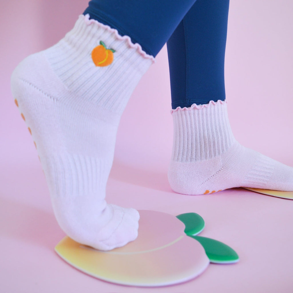 light pink grip sock with peach shaped slider