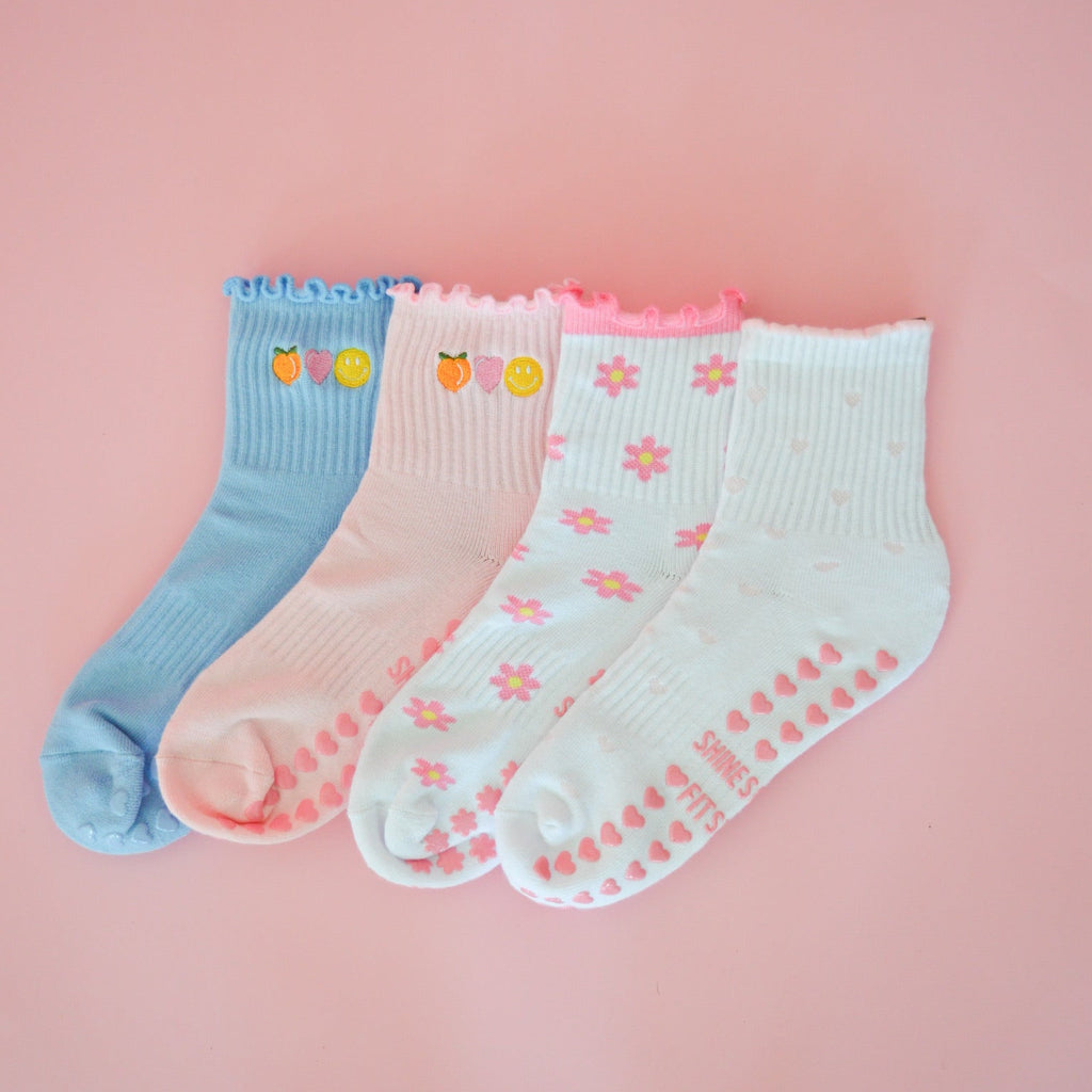 4 pairs of pilates grip socks with pink and blue heart and flower designs