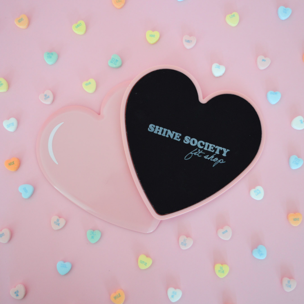 Heart-shaped fitness slider with 'Shine Society' branding on a pink background with colorful heart shapes.