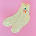 Yellow socks with a palm tree and ice cream design on a pink background