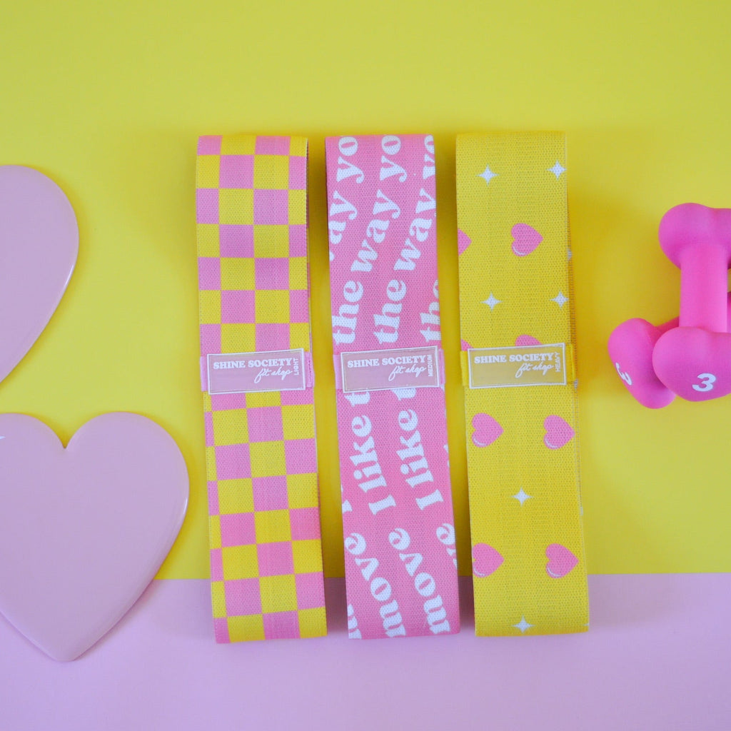 3 hip Resistance bands, a set of heart shaped sliding disks, a set of 3 pound dumbbells