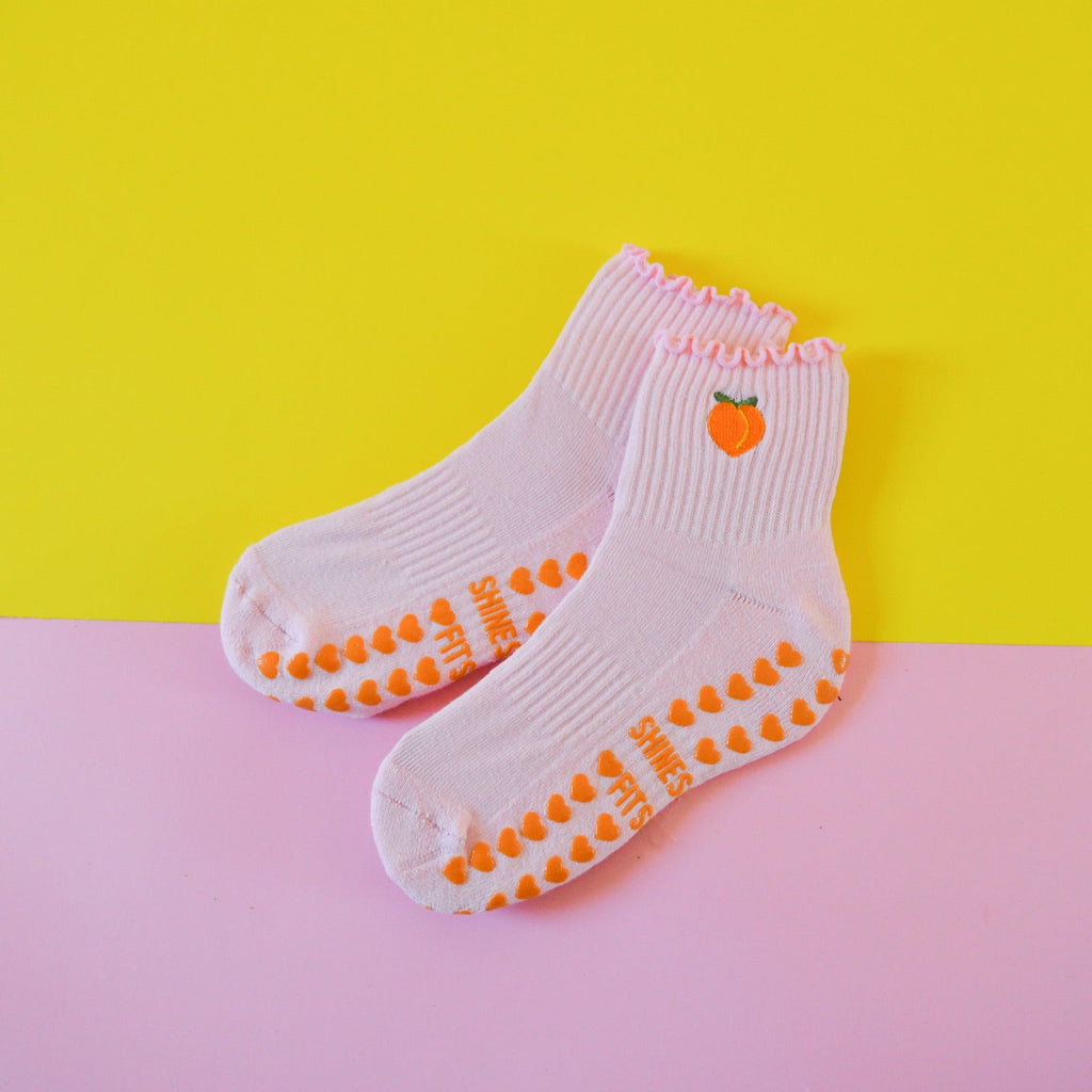 Grip socks with peach on yellow and pink background