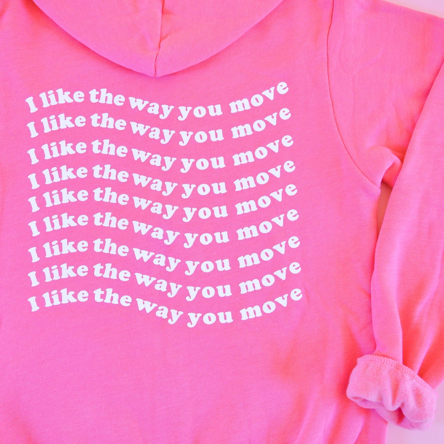 Pink hoodie sweatshirt with text 'I like the way you move' tagline