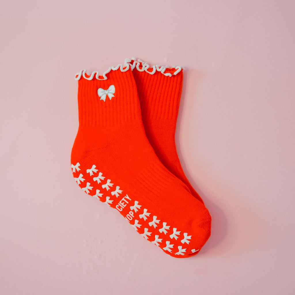red grip socks with silver and white bow with white bow grips and white ruffle at ankle