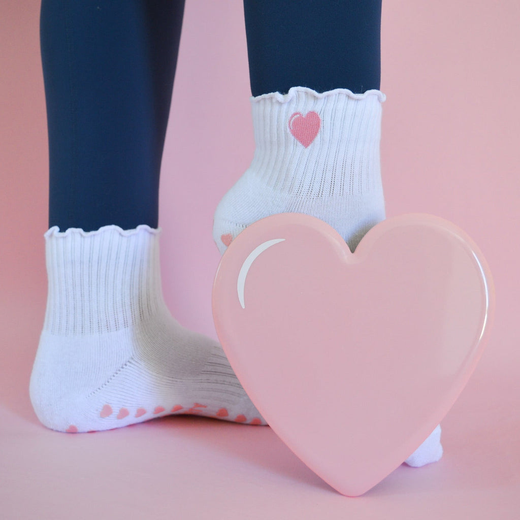 White socks with heart design and a heart sliding disk