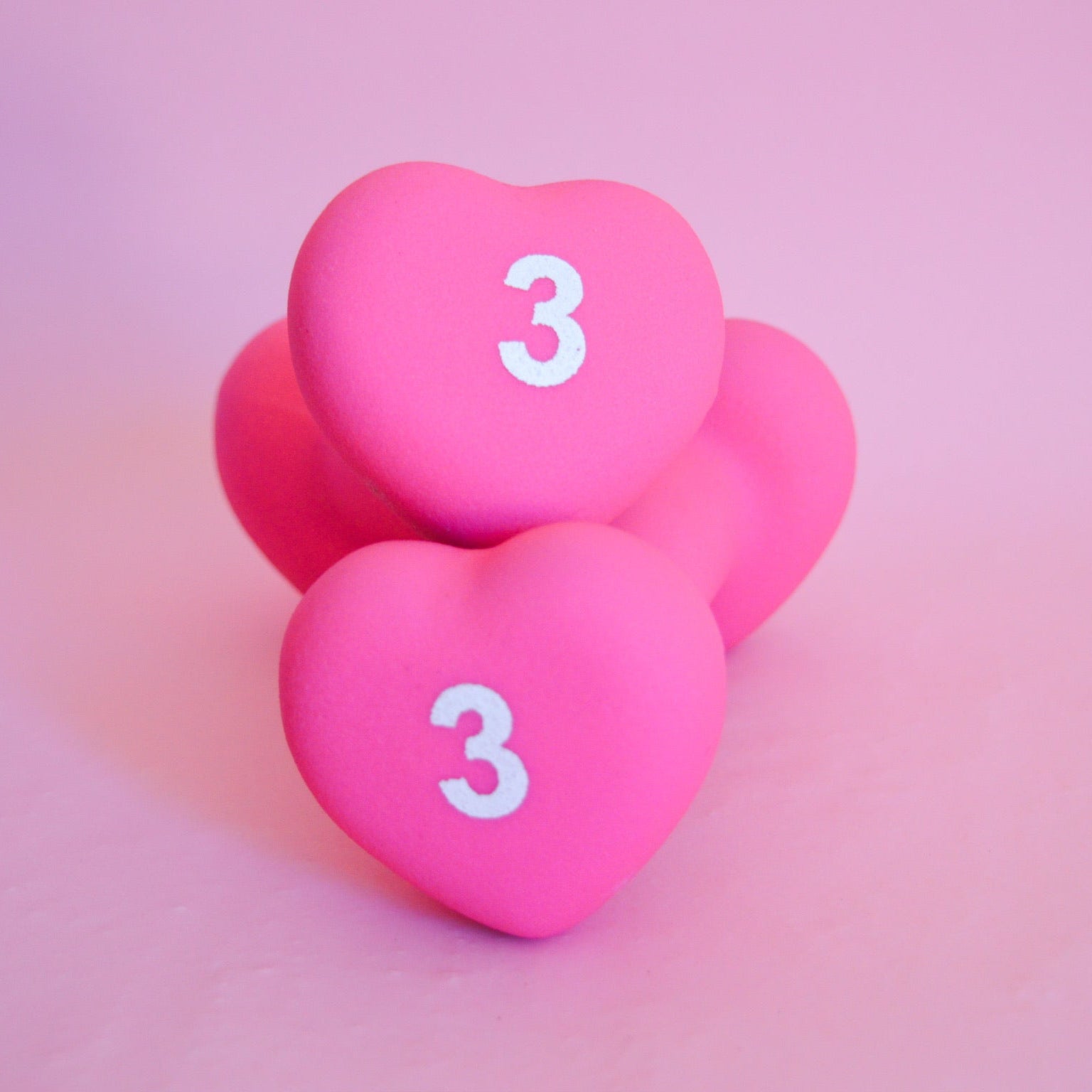 2 pink heart-shaped 3 pound weights 