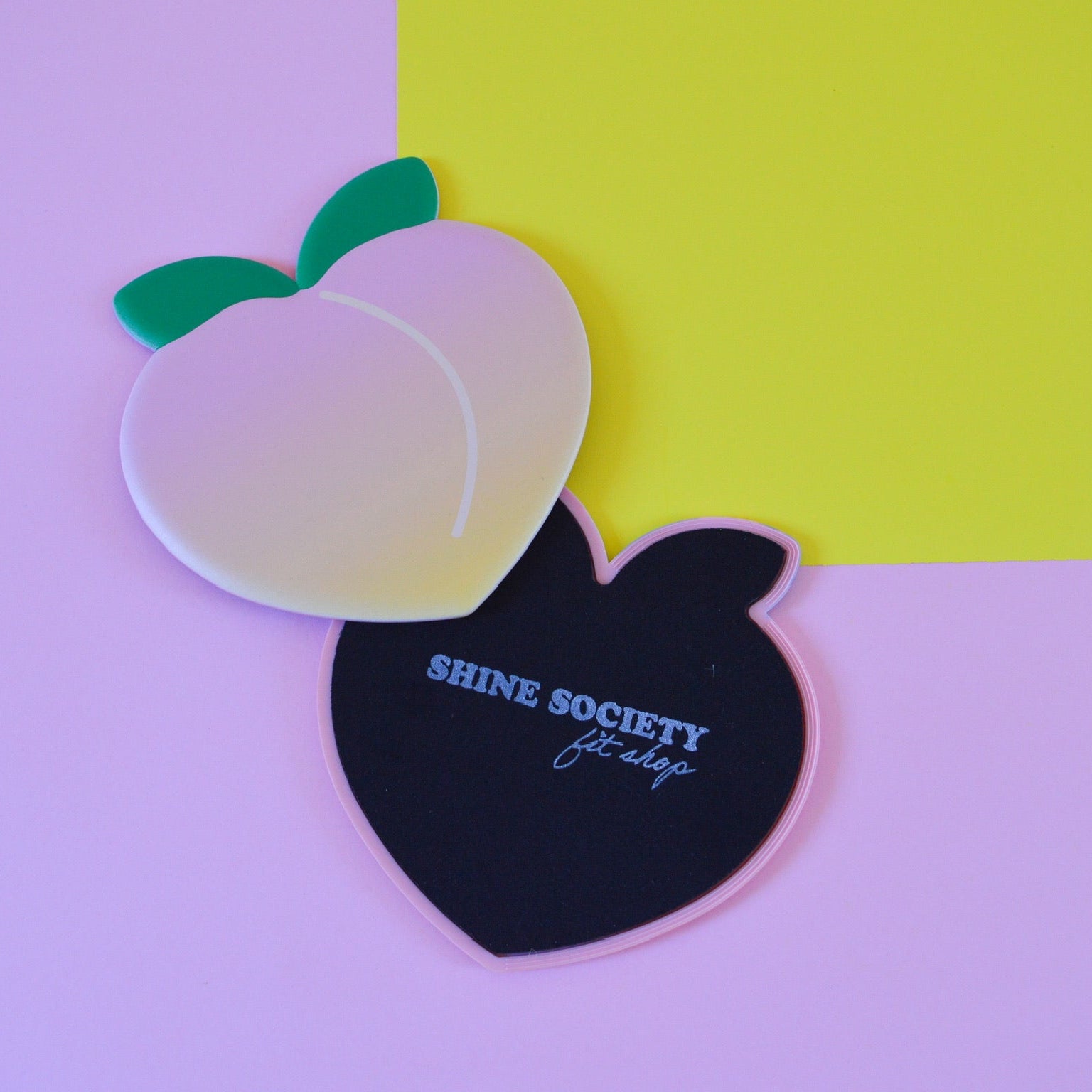 Peach-shaped sliding disks with gradient color and 'Shine Society' branding on a colorful background