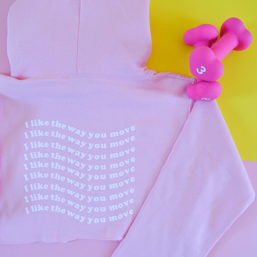 Pink hoodie with I like the way you move text and pink dumbbell on a yellow background