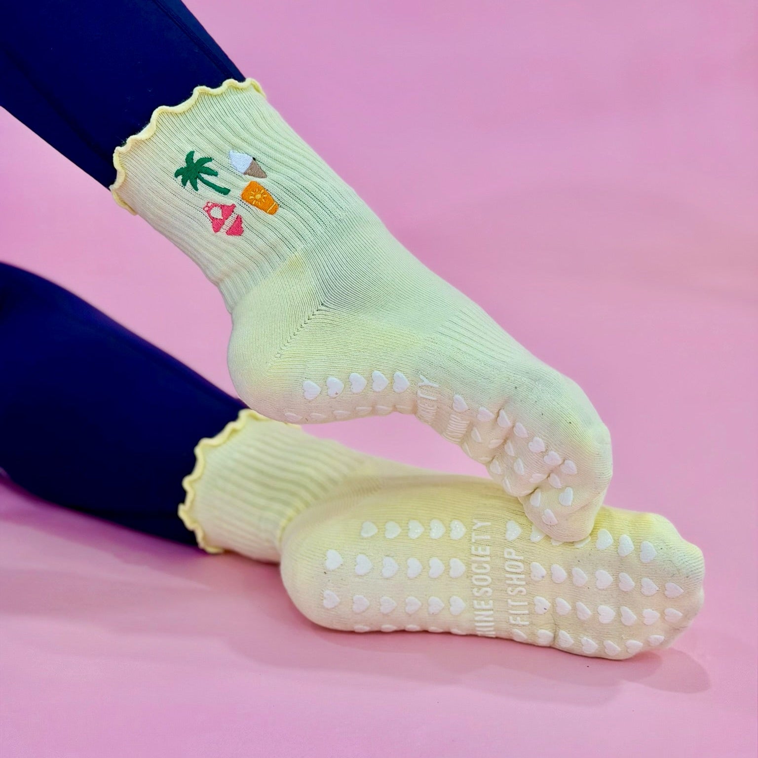 Yellow grip socks with a bikini, palm tree, ice cream and SPF emboidery