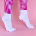 Pink checkered pants and white socks with mini pink hearts on a pink background