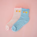 Two pairs of colorful socks on a pink background