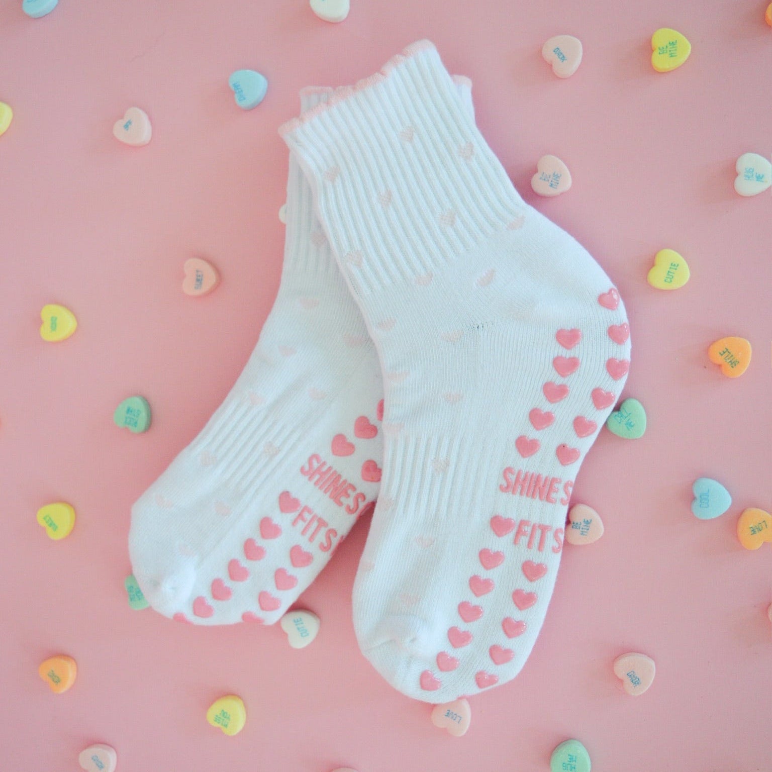 white grip socks with light pink hearts and heart grips, pilates grip socks
