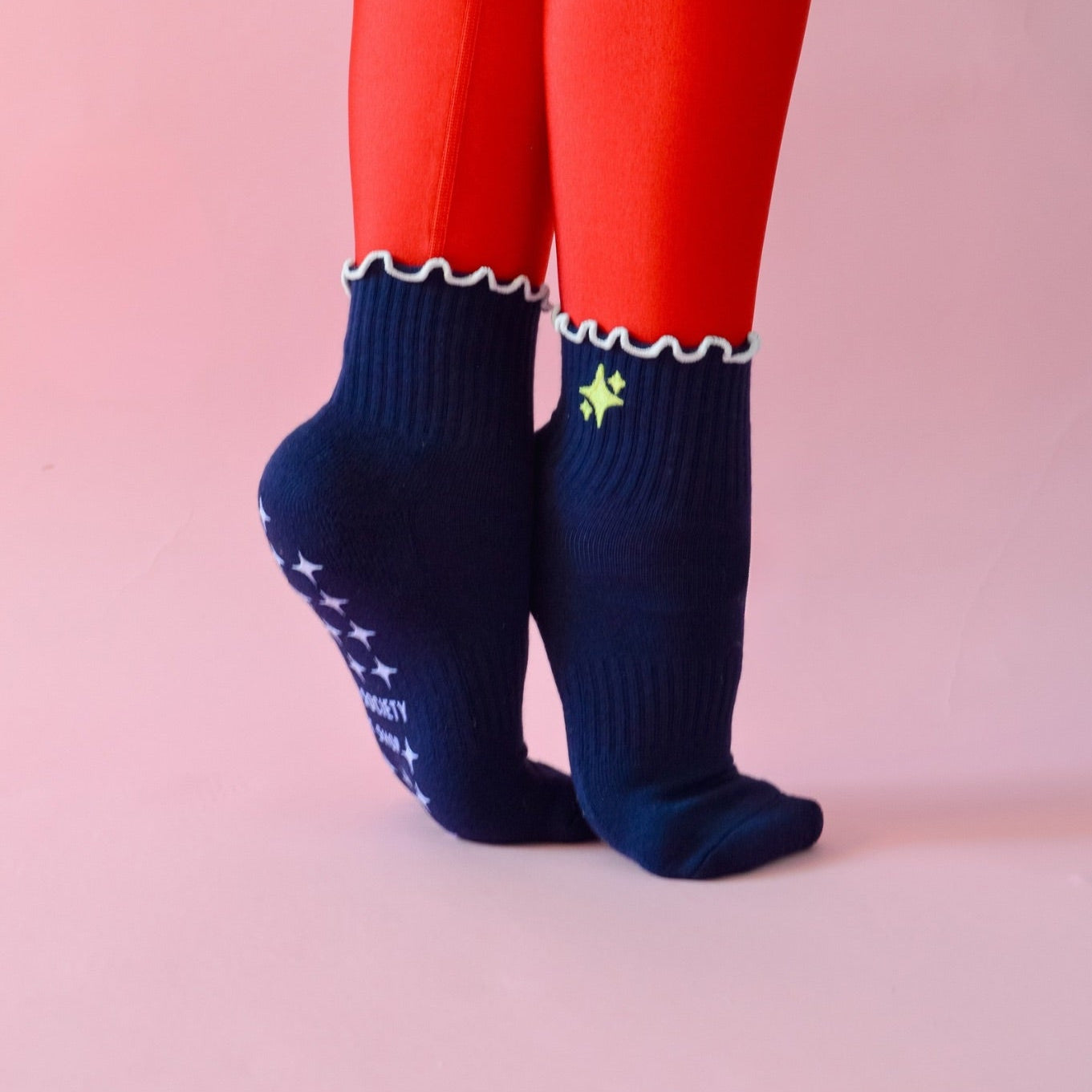 navy sparkle grip socks with glitter yellow sparkle emoji and white ruffle