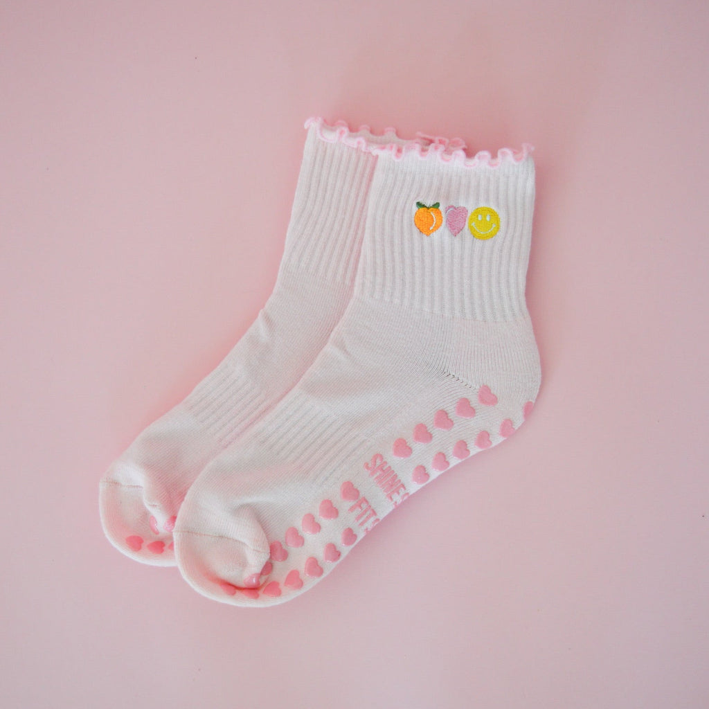 pink pilates grip socks with peach, heart and happy face detail