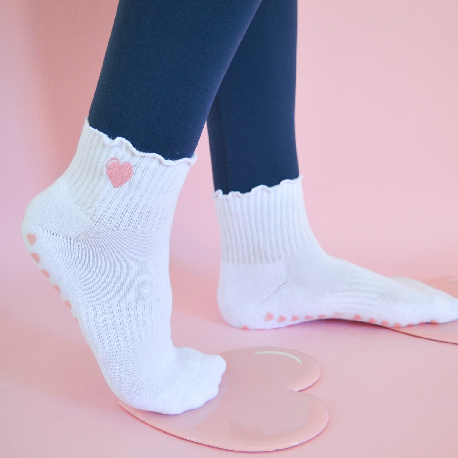 White socks with heart design with pink heart sliding disks