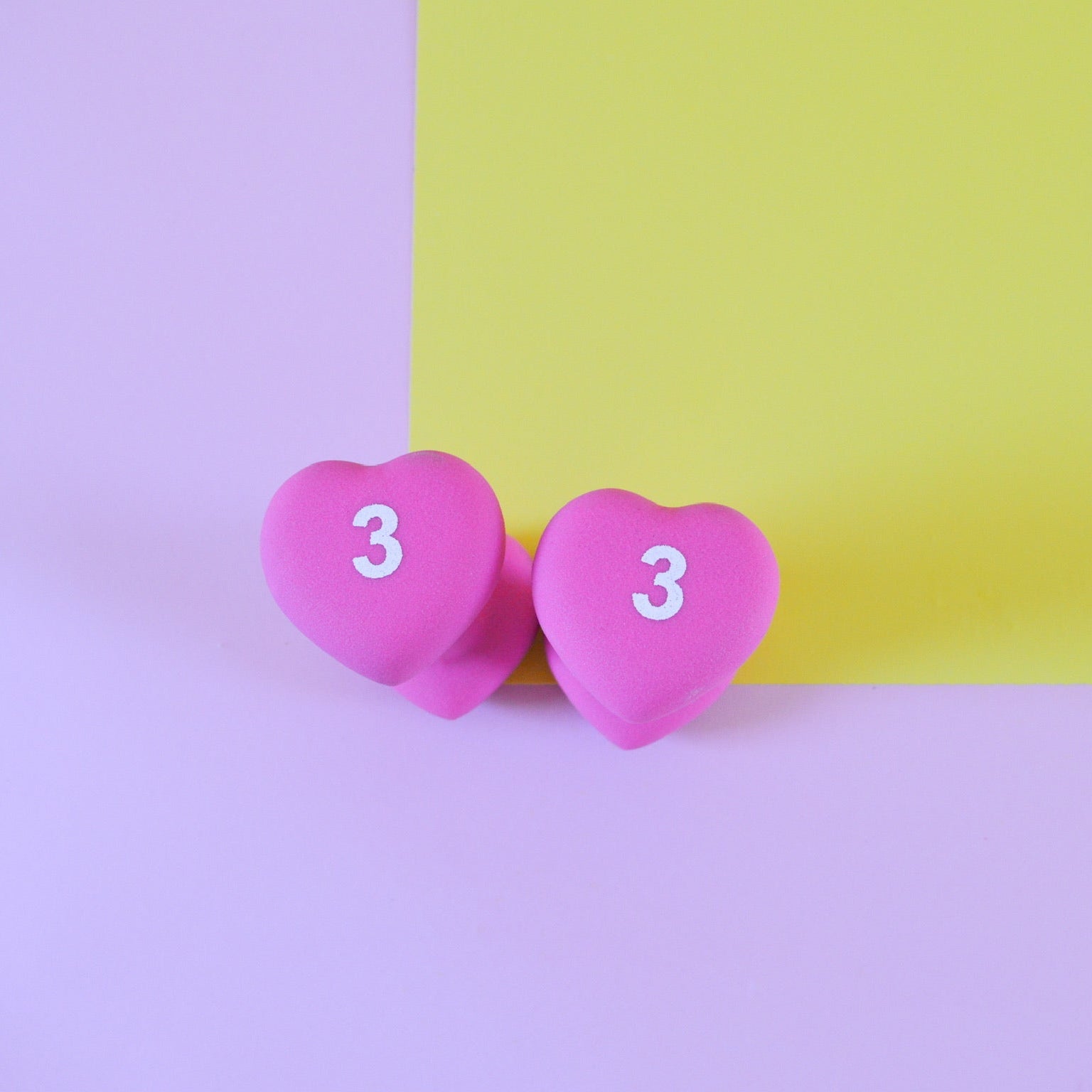 Two pink heart-shaped weights 3 pounds
